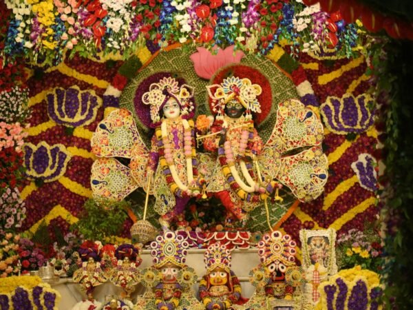 Radha Krishna idols with flowers