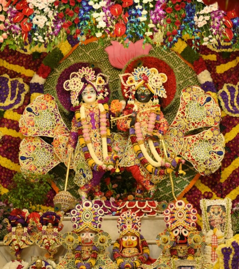 Radha Krishna idols with flowers