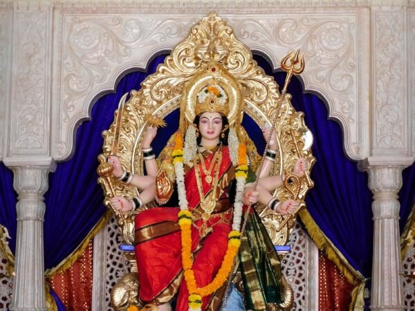 Gold and red Hindu deity idol
