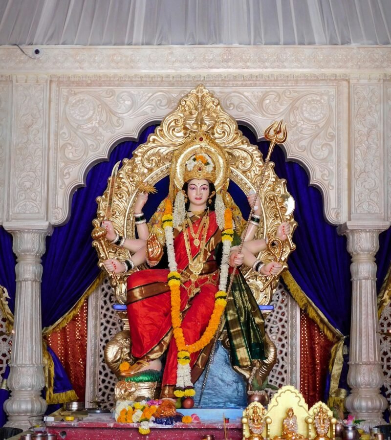 Gold and red Hindu deity idol