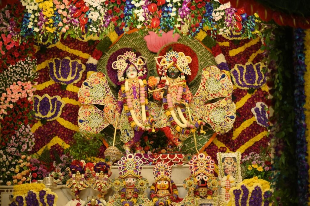 Radha Krishna idols with flowers