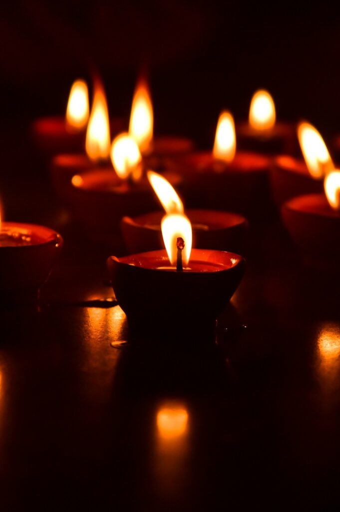 Decorative diya candles on wooden surface